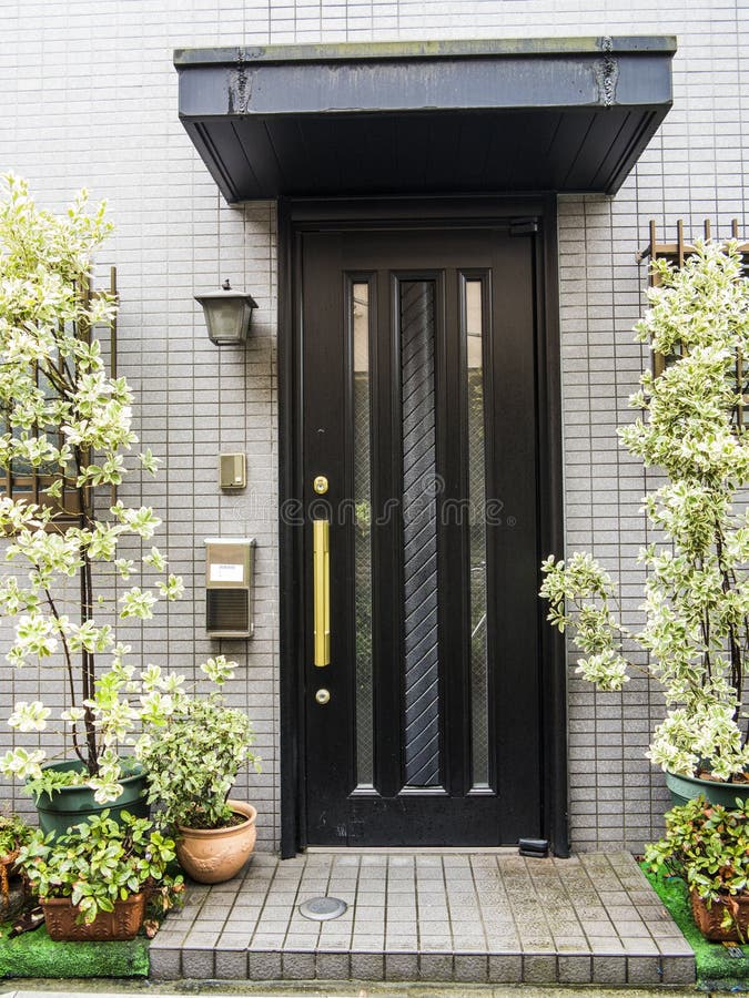 Front door. Japanese front door with glass panels and plants royalty free stock photo